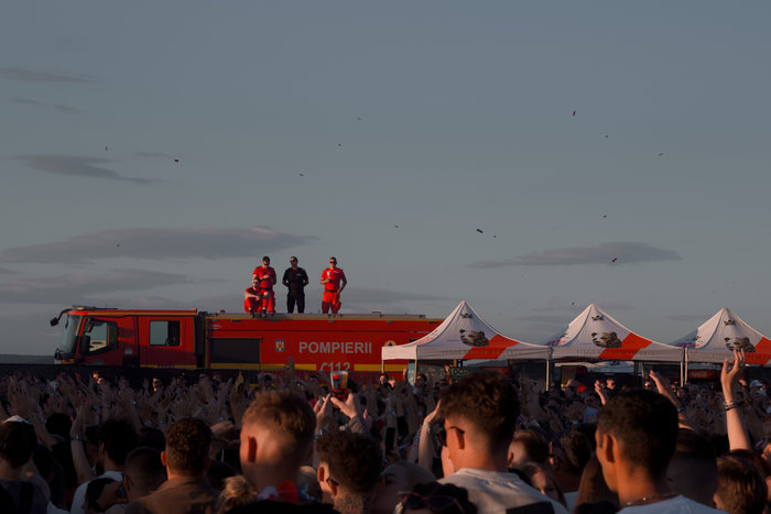 Firefighters looking over the crowd at a music festival